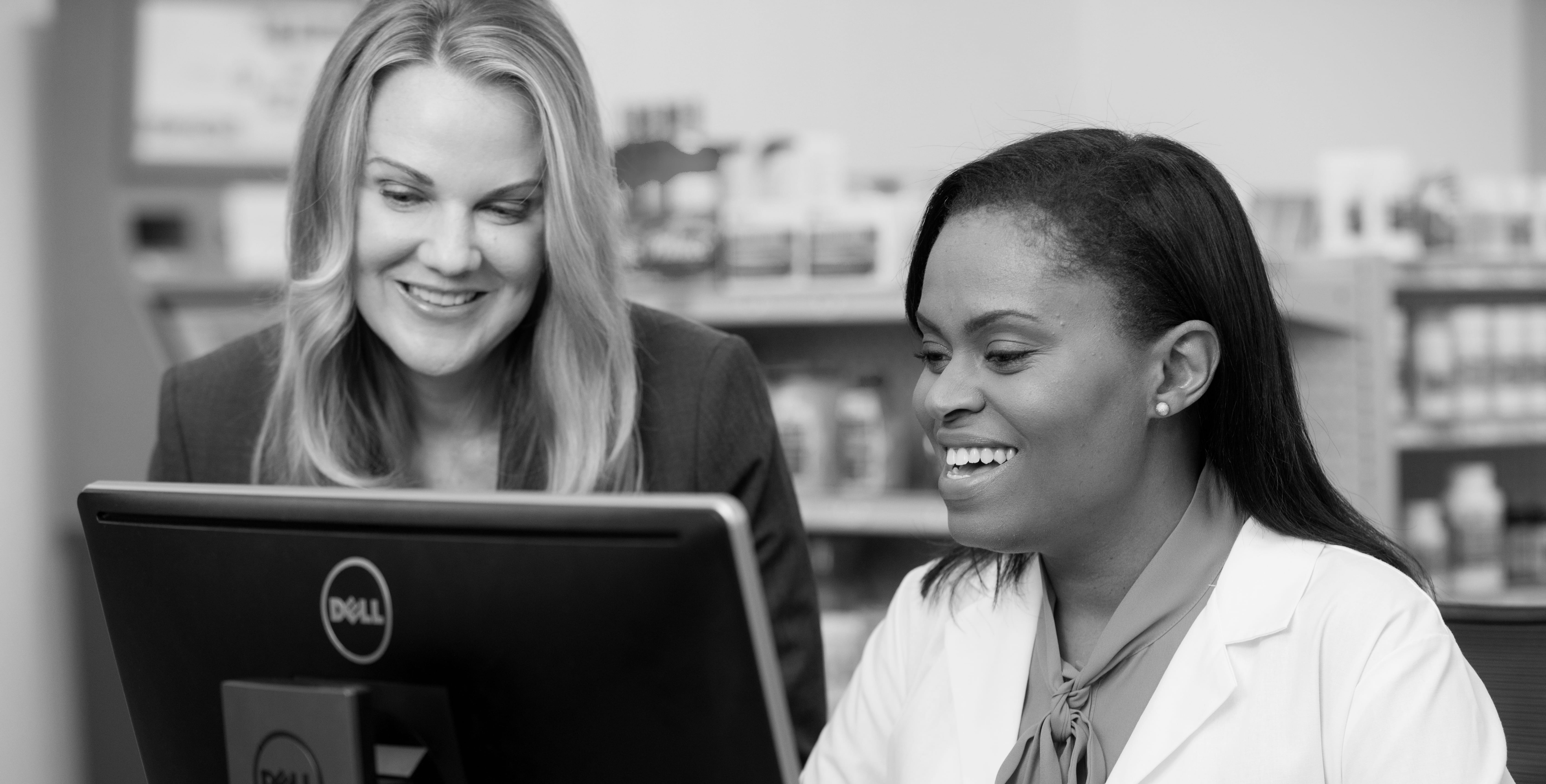 Business coach and pharmacist review a case study