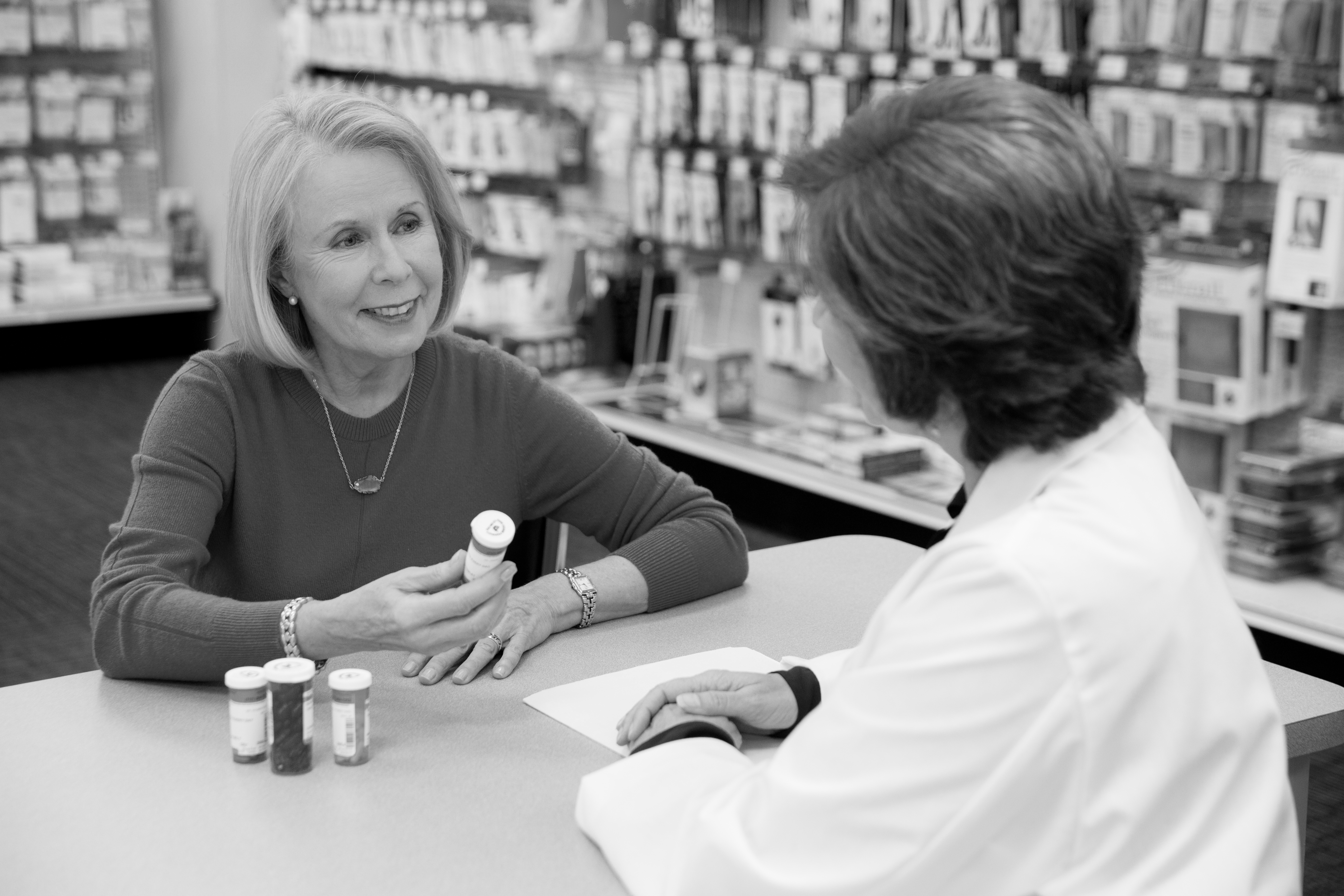 A pharmacist consulting a patient on her medications