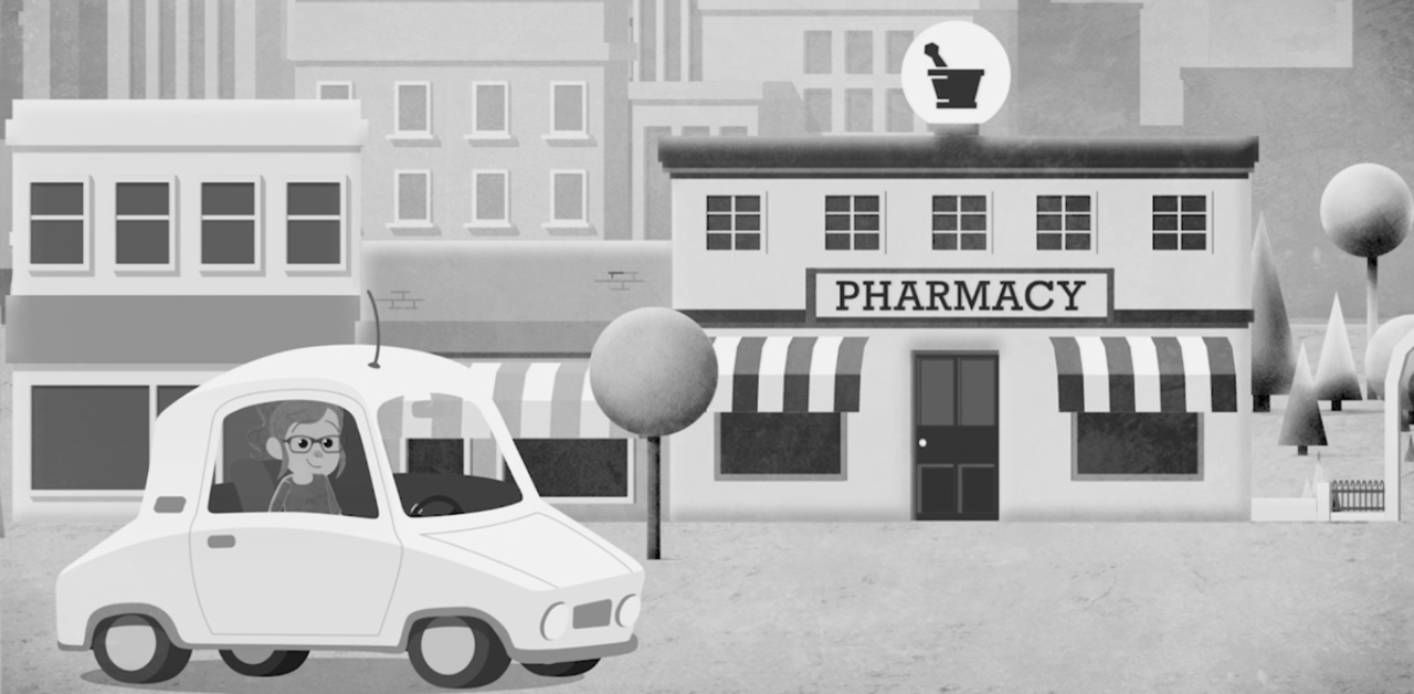 A woman driving her car to a local independent pharmacy
