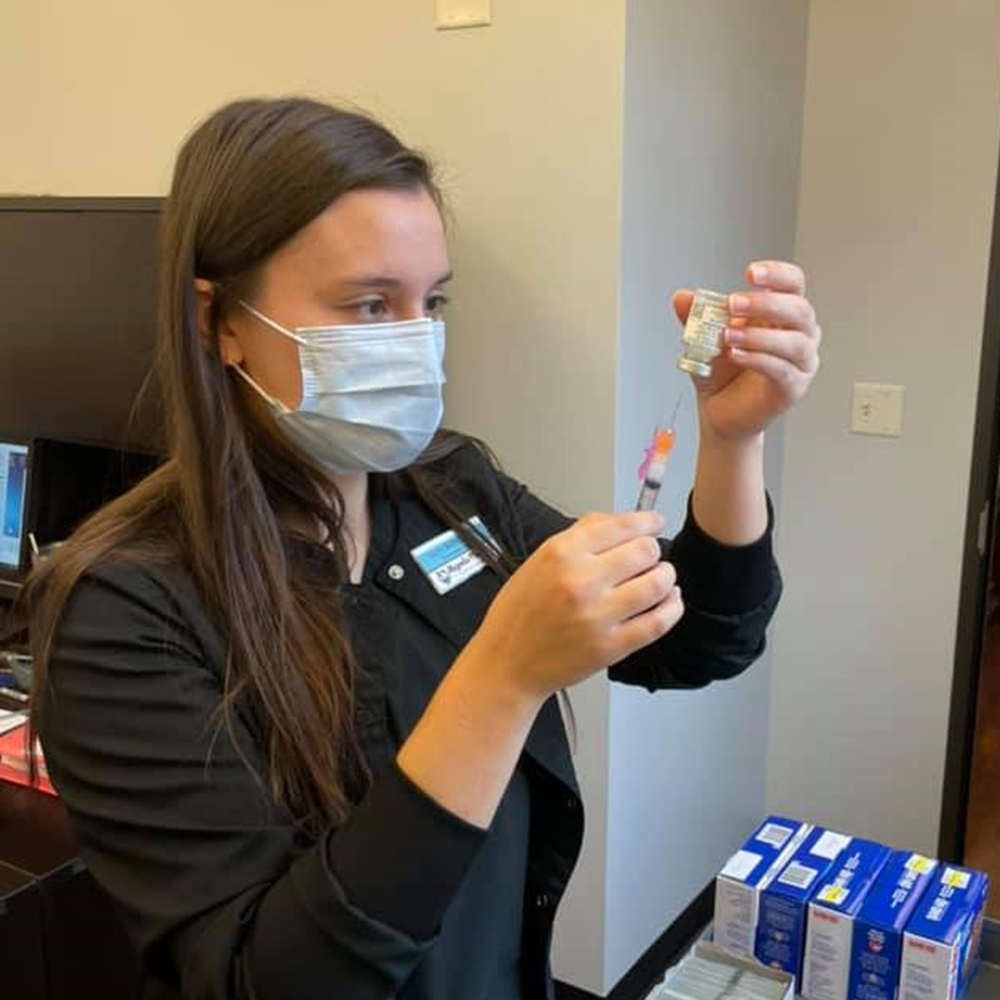 Magnolia Pharmacy administering the COVID-19 vaccine