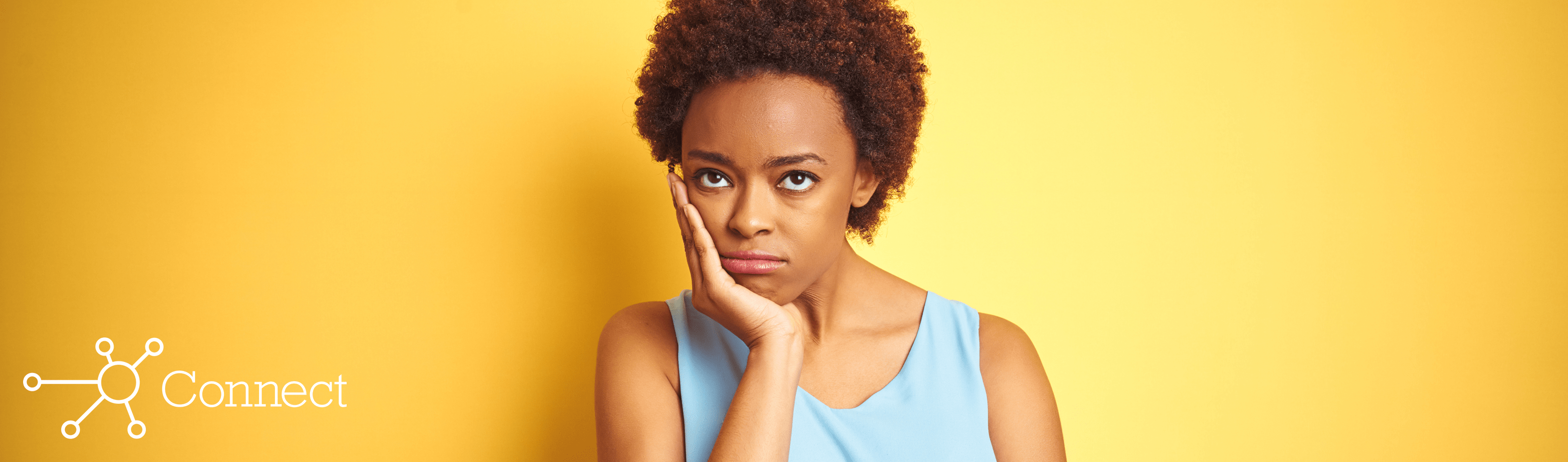 A woman holding her chin in her hand and looking annoyed